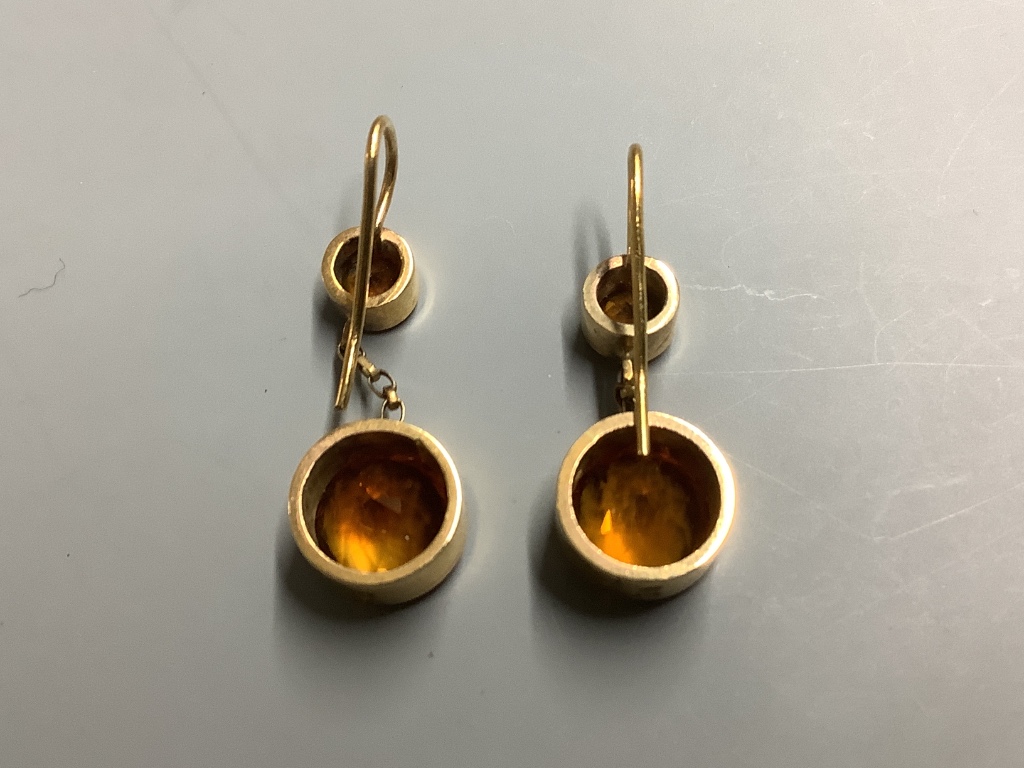 A pair of yellow metal and two stone citrine set drop earrings